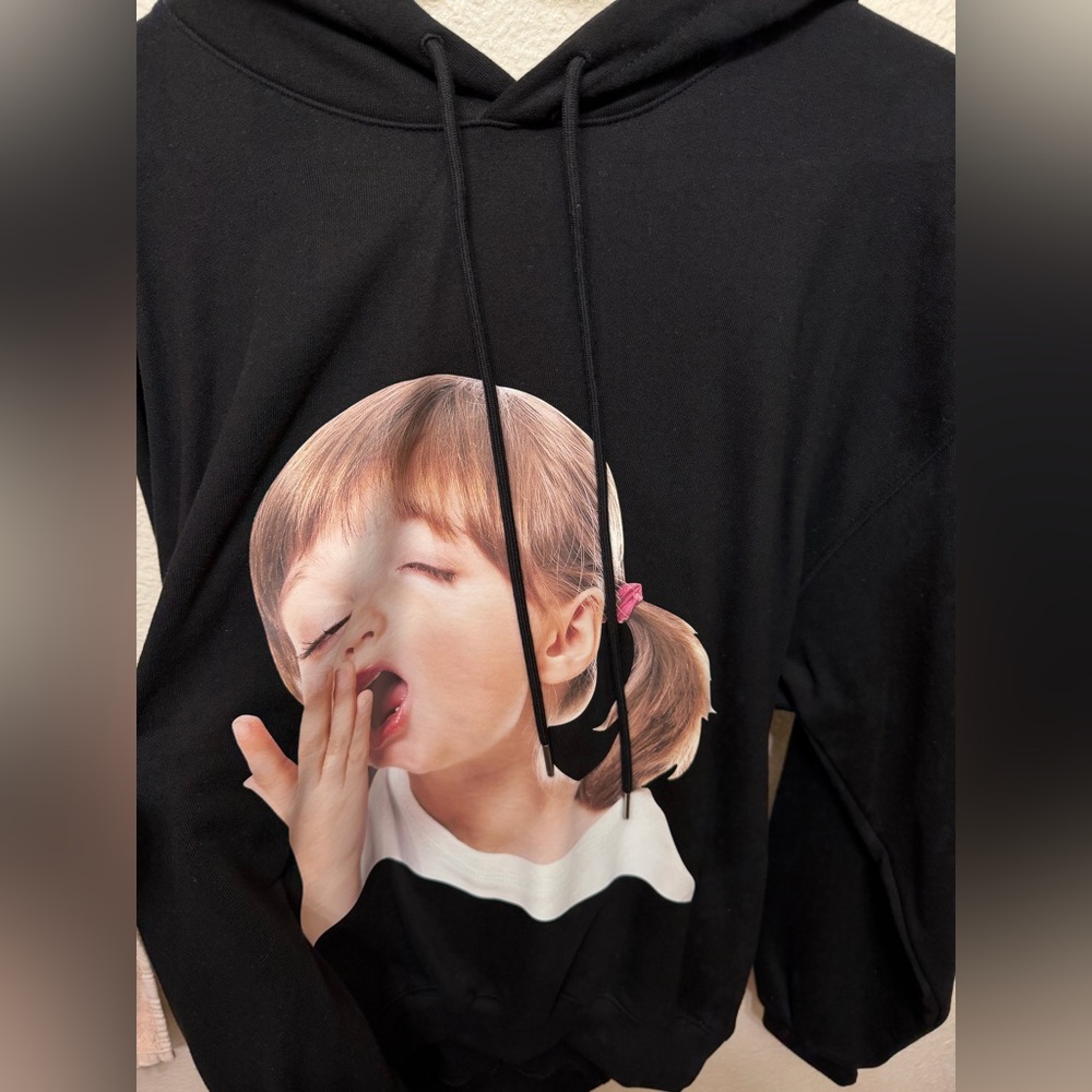 Black Graphic Hoodie with Yawning Child Design